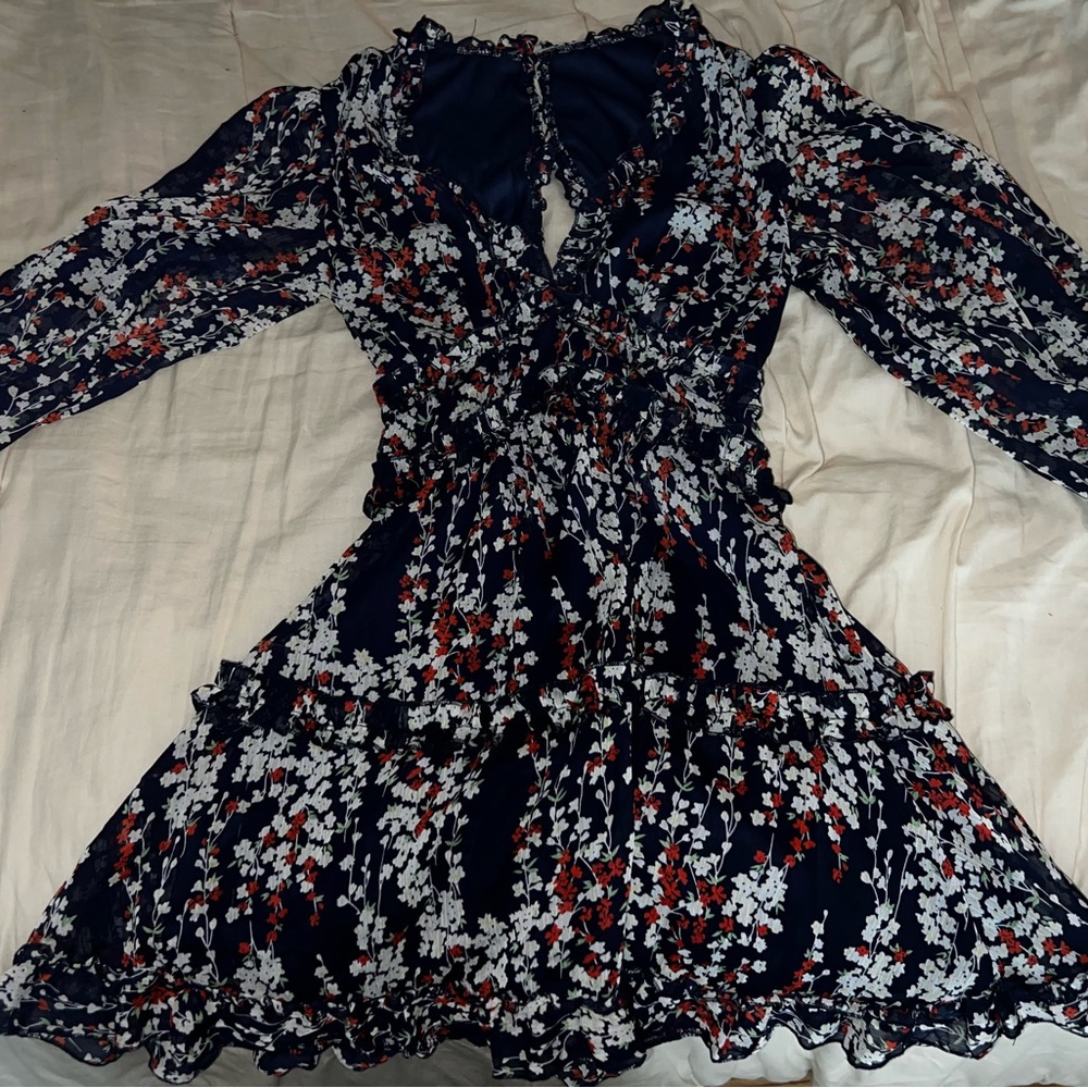 Above the knee length dress with a opening in the back and sheer sleeves